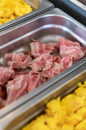 a tray filled with meat and other food items at International Hotel & Suite in San Benedetto del Tronto
