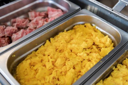 a tray of food with pineapple and other meats at International Hotel & Suite in San Benedetto del Tronto