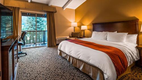 a hotel room with a bed and a large window at Best Western Tyrolean Lodge in Ketchum