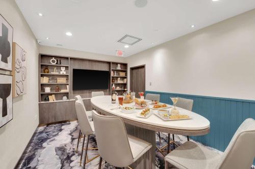 a conference room with a table and chairs and a television at Hilton Garden Inn Toronto/Brampton in Brampton