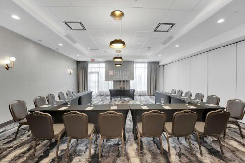 a conference room with a large table and chairs at Hilton Garden Inn Toronto/Brampton in Brampton