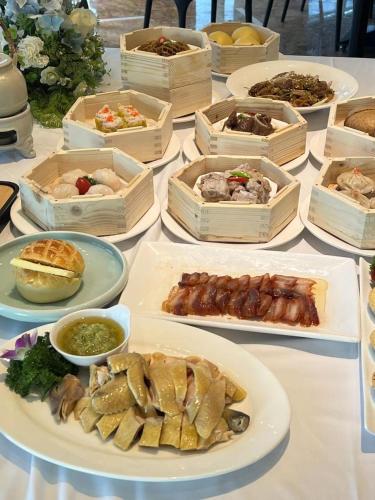 a table full of different types of food on plates at Days Hotel & Suites China Town---Five minutes to reach Changsha Station, the metro Line 2 & Line 6 are nearby,free gym & laundromat,Chinese and Western buffet breakfast is offered on the 31st floor in Changsha