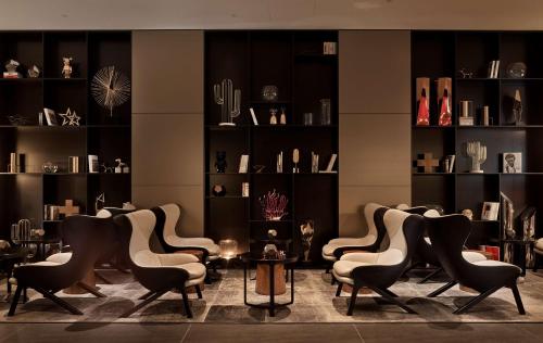 a group of chairs in a room with shelves at Park Plaza London Riverbank in London