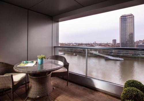 a room with a table and a view of a river at Park Plaza London Riverbank in London
