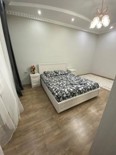 a bedroom with a bed in a white room at Двухкомнатные бизнес апартаменты в ЖК Томирис in Atyraū
