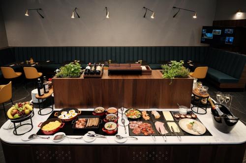 a buffet line with many different types of food at Palatinus Boutique Hotel in Pécs