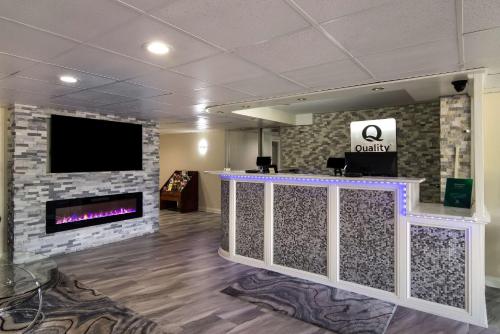 a lobby with a fireplace and a flat screen tv at Quality Inn Aurora - Naperville Area in Aurora