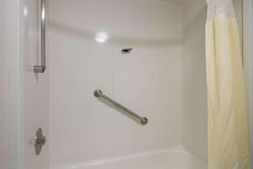 a shower with a curtain next to a white tub at Quality Inn Aurora - Naperville Area in Aurora