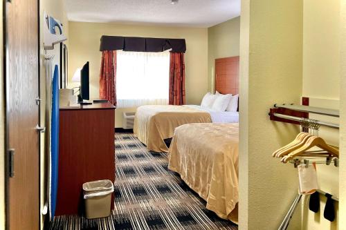a hotel room with two beds and a window at Quality Inn & Suites Wisconsin Dells Downtown - Waterparks Area in Wisconsin Dells