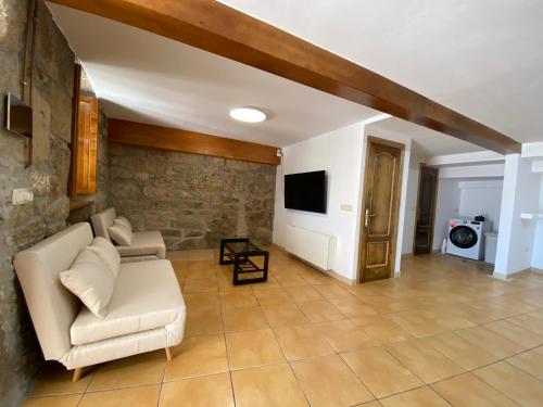 a living room with a couch and a tv at CASA do CAMPO in Lestrove