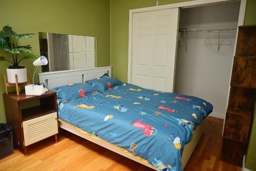 a bed with a blue comforter with crabs on it at # 2 Charming Queen Bed - Shared Room - Business Travel! By Zen Living Short Term Rental in Brooklyn