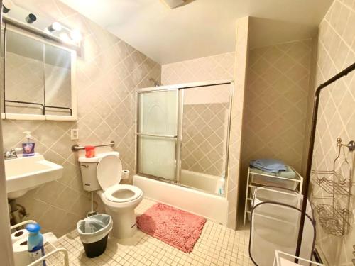 a bathroom with a toilet and a shower and a sink at # 2 Charming Queen Bed - Shared Room - Business Travel! By Zen Living Short Term Rental in Brooklyn