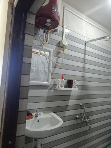 a bathroom with a sink and a window at Wonder Hill Parivaar homestay in Darjeeling