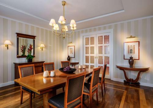 a dining room with a wooden table and chairs at Hotel Nassauer Hof in Wiesbaden