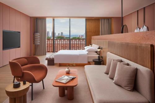 a hotel room with a bed and a couch at TAOXICHUAN Hotel in Jingdezhen