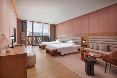 a hotel room with a bed and a couch at TAOXICHUAN Hotel in Jingdezhen