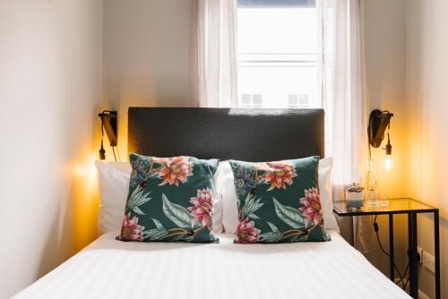 a bedroom with a bed with two pillows and a window at CitySpace Borough in London