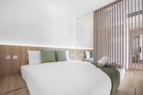 sypialnia z dużym białym łóżkiem i dużym lustrem w obiekcie Cozy Dubai Marina Design Studio close to Jumeirah Beach, Mall & Metro w Dubaju
