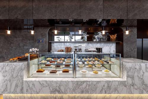 a display case filled with different types of pastries at Wyndham Grand Busan in Busan