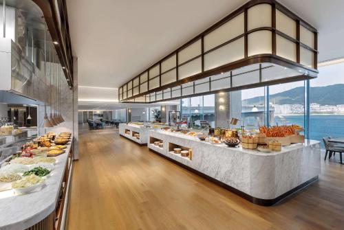 a buffet in a restaurant with a view of the ocean at Wyndham Grand Busan in Busan