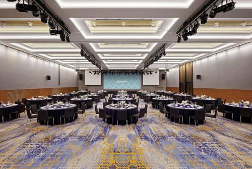 a large banquet hall with tables and chairs in a room at Wyndham Grand Busan in Busan