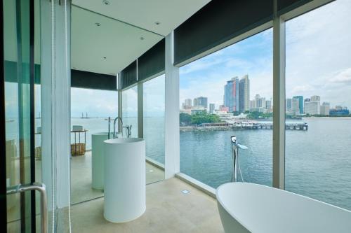 a bathroom with a view of the water at Hotel H2O in Manila