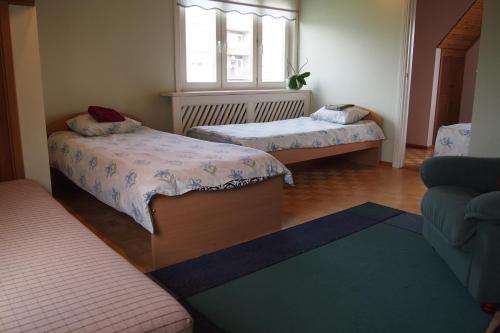 a small room with two beds and a window at Männi Holiday House in Haapsalu