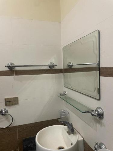 a bathroom with a sink and a mirror at Warraich villa gt raod gujrat entire in Gujrāt