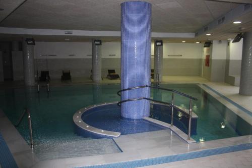 a swimming pool with a blue column in a building at Bahia de la Plata in Estepona