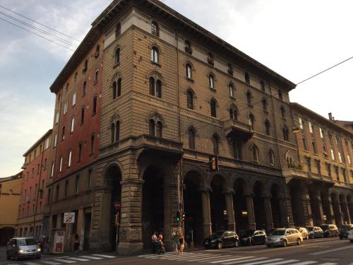 a large brick building with cars parked on a street at B & B 21 Bologna in Bologna