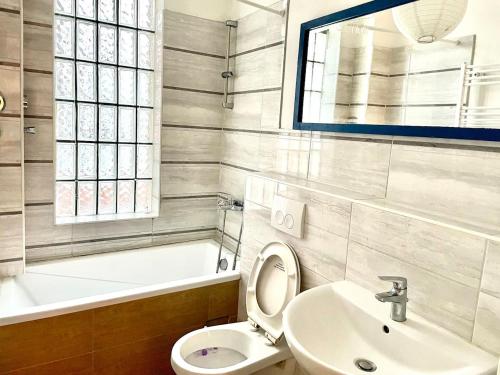 a bathroom with a toilet and a sink and a tub at Hamburg Billstedt Center in Hamburg