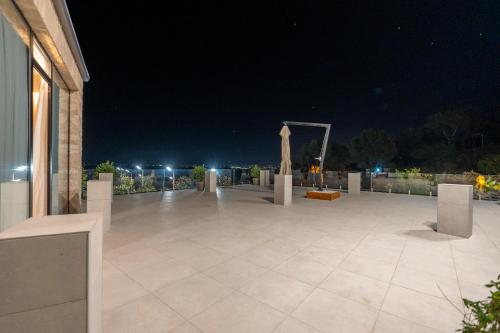 a night view of a large patio with lights at Duomo Resort in Shkodër