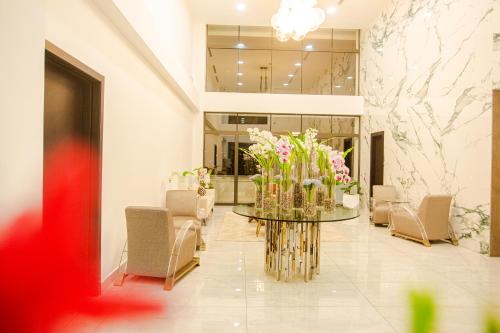 a lobby with a table with flowers on it at Accra Luxury Apartments @ The Signature in Accra