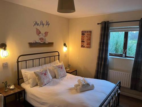 a bedroom with a bed with two towels on it at Farmyard Inn in Youlgreave