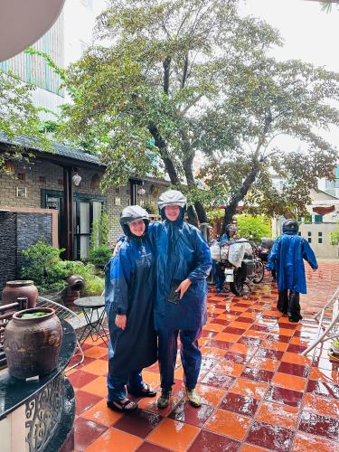 a group of people standing in the rain at Nana Homestay & Villa in Hue