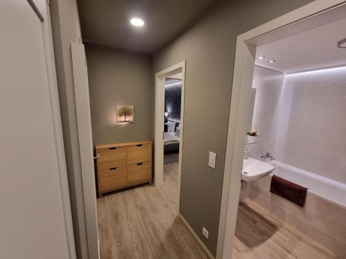 a bathroom with a sink and a toilet and a mirror at RiverCity Apartments in Budapest