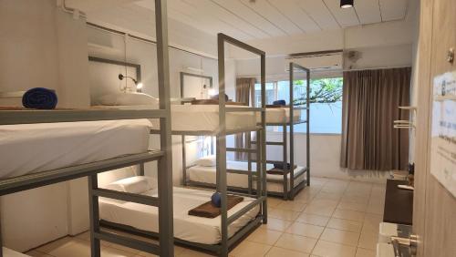a room with four bunk beds in a room at iRest Ao Nang in Ao Nang Beach