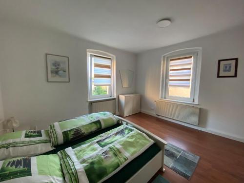 um quarto com 2 camas e 2 janelas em Pension Anna em Löbau