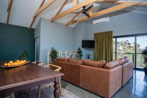 a living room with a couch and a table at Wolfkop Nature Reserve in Citrusdal