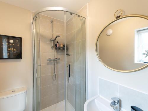 a bathroom with a shower with a sink and a mirror at Pass the Keys Contemporary 2 bedroom home in Ludlow