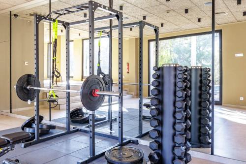 a gym with a row of weights and dumbbells at Hotel Eden Nord Soller in Port de Soller