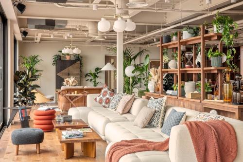 a living room with white couches and plants at ARK Wembley in London