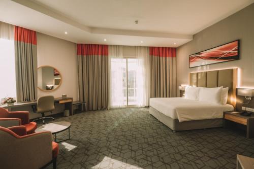 Postel nebo postele na pokoji v ubytování Peony Hotel