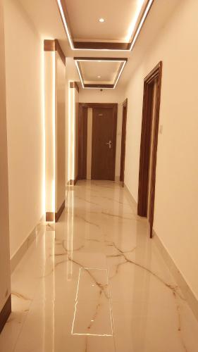 a hallway with a tile floor and a door at S.S Guest House in Varanasi