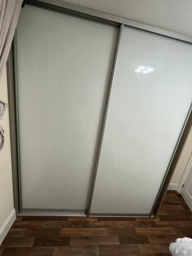 a set of three sliding glass doors in a room at Cosy room away from home in Yate