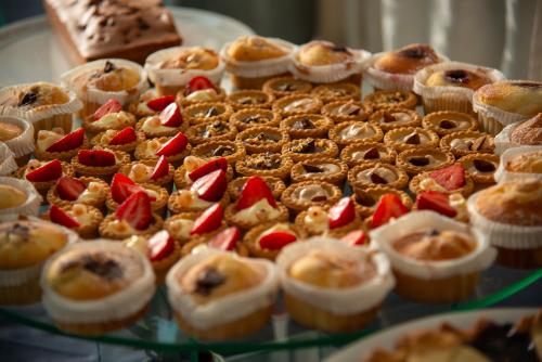 a display of pastries on a glass table at Hotel Parco Delle Agavi in Ischia