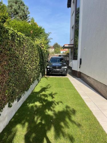 a car parked in the driveway of a house at A.V.E. Pension Kliská in Prague