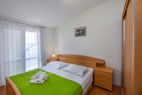 Ένα ή περισσότερα κρεβάτια σε δωμάτιο στο Apartments Jasna