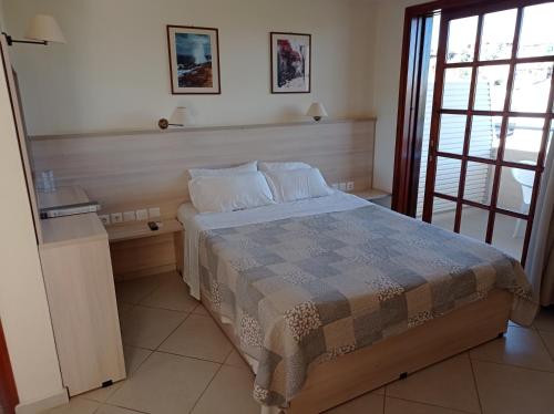 a bedroom with a bed and a window at Alexandros Studios in Kalamaki Chanion