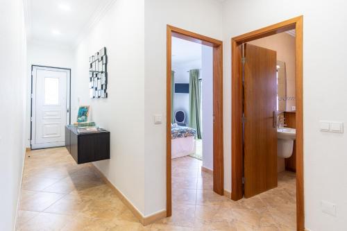 a hallway with a mirror and a bathroom at Chalé d'Angra Guest House in Angra do Heroísmo